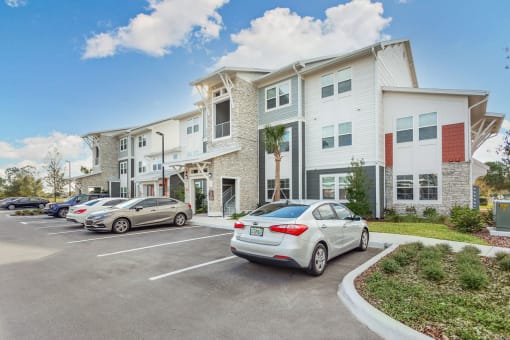 a parking lot with cars in front of a building