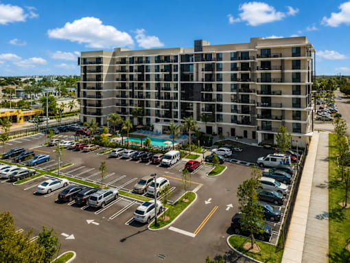 A parking lot in front of a large building.