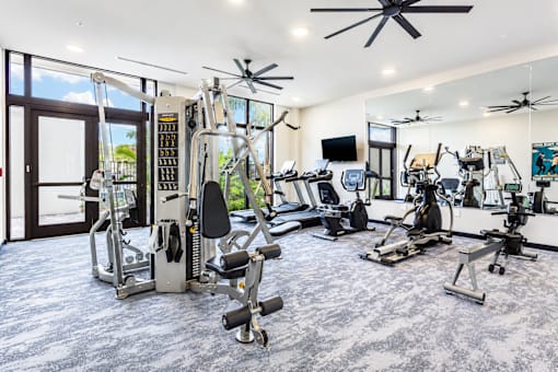 A spacious home gym with a variety of exercise equipment.
