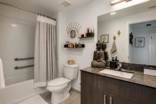 A bathroom with a toilet, sink, and shower.