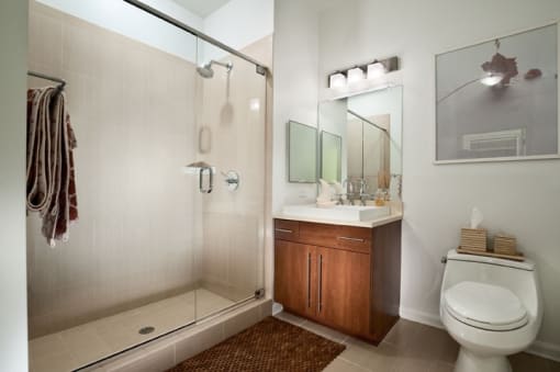 a bathroom with a toilet sink and shower  at The Sheffield Englewood, Englewood, 07631