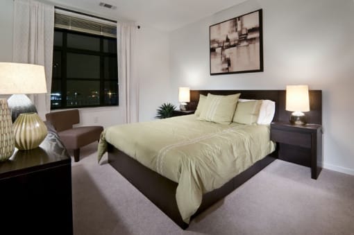 a bedroom with a large bed and a large window  at The Sheffield Englewood, Englewood, 07631