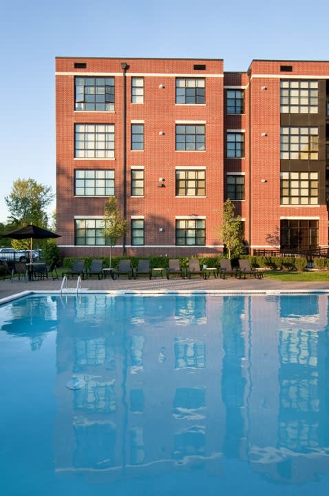 a swimming pool in front of a red brick building  at The Sheffield Englewood, Englewood, New Jersey