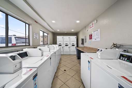 A row of washing machines in a laundromat.