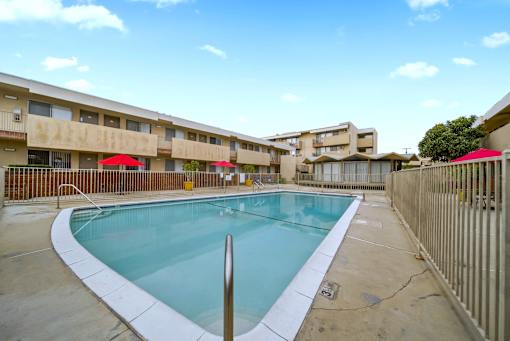 A swimming pool in a courtyard surrounded by buildings.