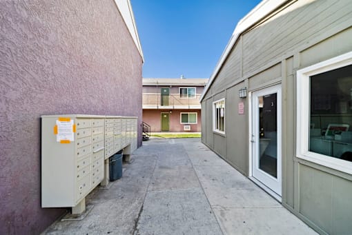 A building with a pink wall and a white door.