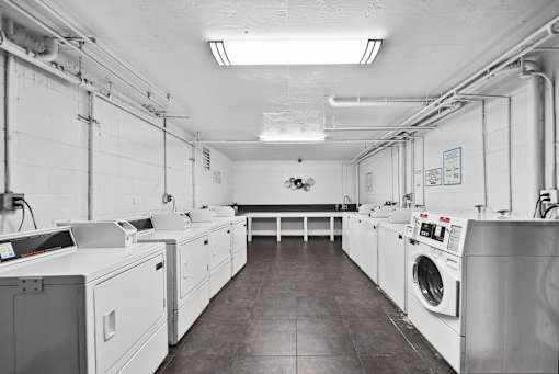 A laundry room with washers and dryers.