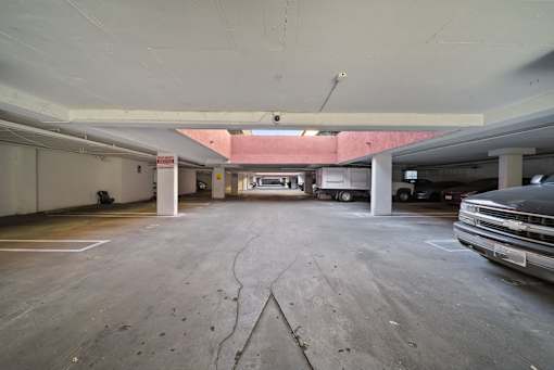 A Chevy truck is parked in a large, empty parking garage.