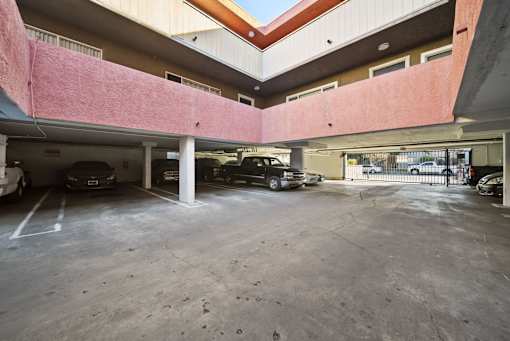 A parking garage with cars parked in it.