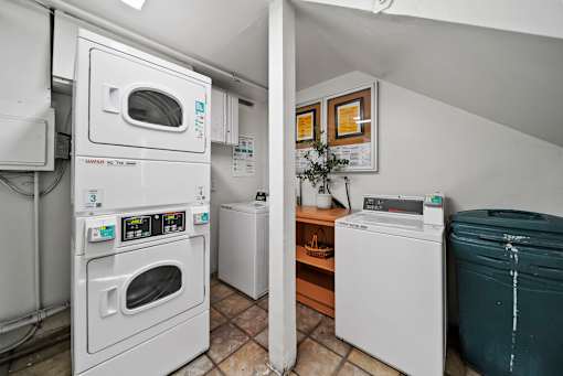 A laundry room with a washer and dryer stacked on top of each other.
