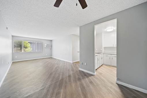 A room with wooden flooring and a ceiling fan.