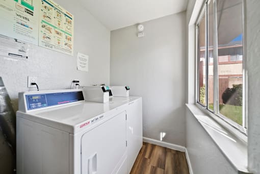 A small laundry room with a washer and dryer.