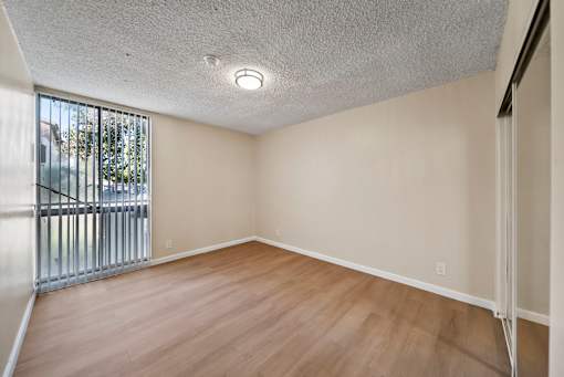 Empty room with wooden floor and white walls.