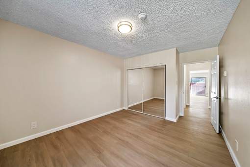 A room with a white ceiling and wooden flooring.