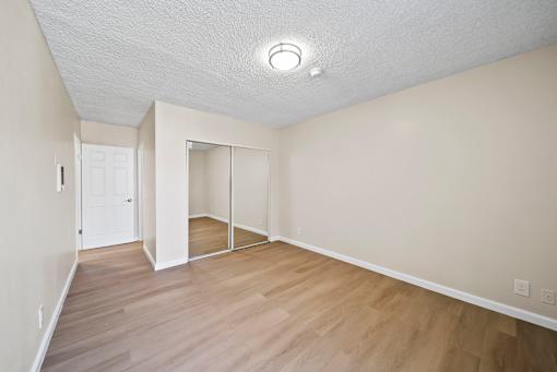 A room with a white ceiling and wooden flooring.