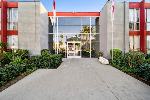 A building with a red and grey exterior and a glass door.