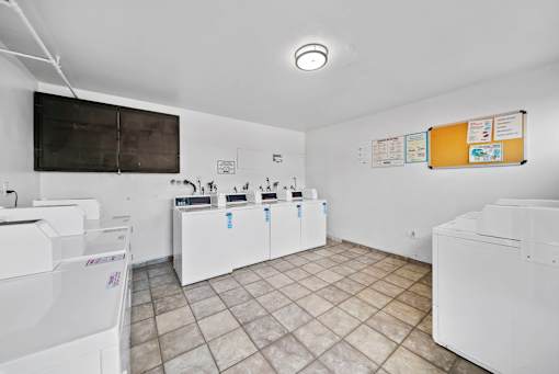 A laundry room with washers and dryers.