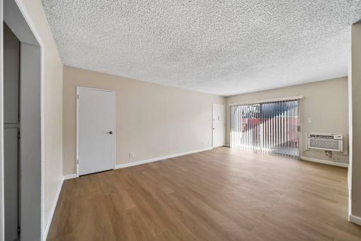 A room with wooden floors and white walls.