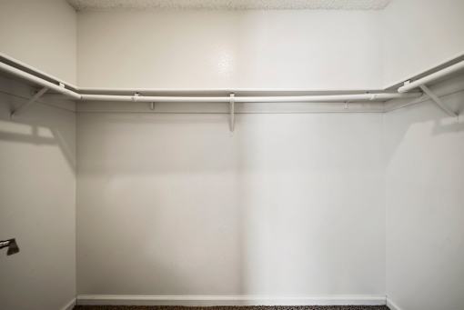 A white wall with a metal pipe running across it.