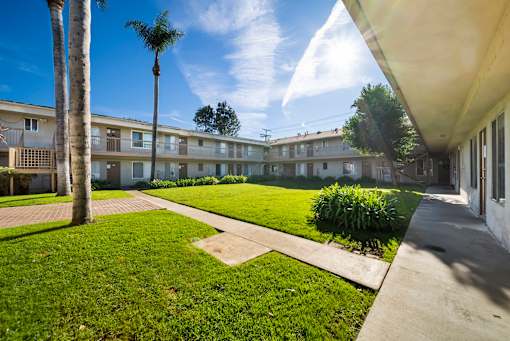 A sunny day at the apartment complex with a clear blue sky.