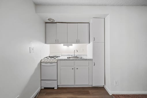 A small kitchen with white appliances and cabinets.