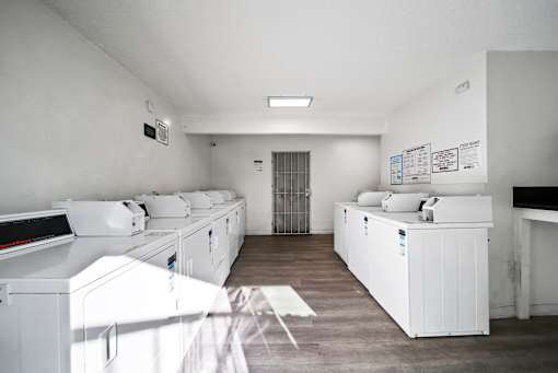 A laundry room with washers and dryers.