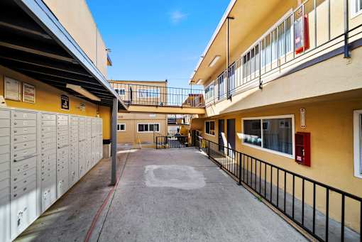 A courtyard between two buildings with a red fire hydrant.