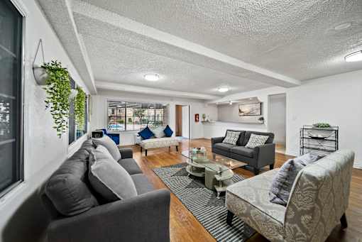 A living room with grey couches and a coffee table.