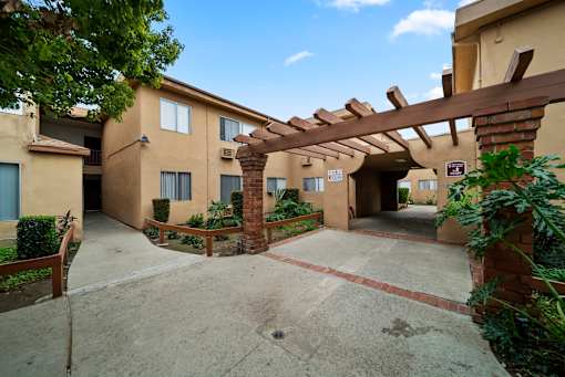A building with a covered walkway and a clear sky.