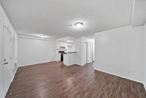 A room with wooden floors and white walls.