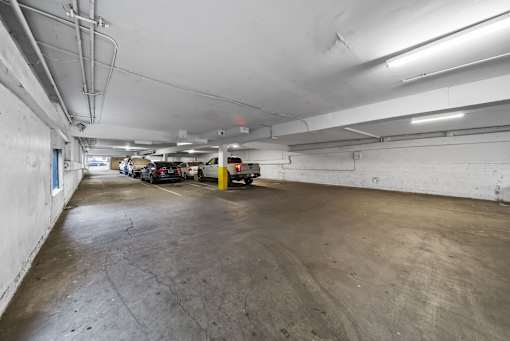 A parking garage with a concrete floor and white walls.
