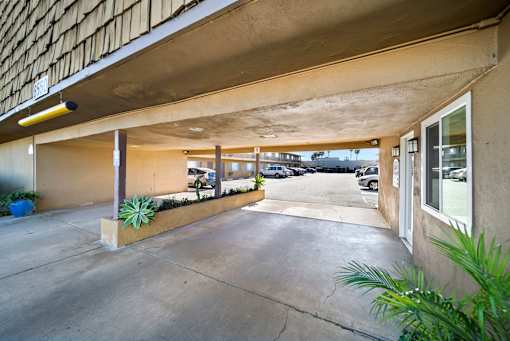 A parking garage with a concrete floor and a concrete ceiling.