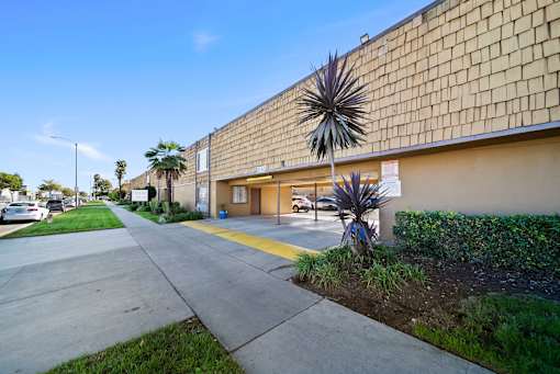 A building with a yellow line on the sidewalk in front of it.