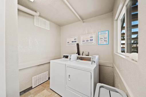 A washing machine is sitting in a small room.