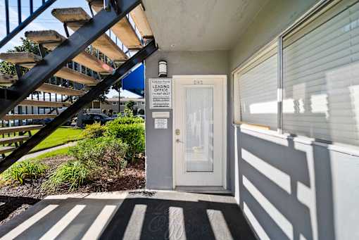A leasing office with a door and a sign on it.