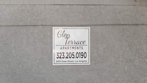 A sign for Glen Terrace Apartments is on a wall.