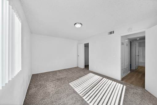 A room with a striped rug on the floor.