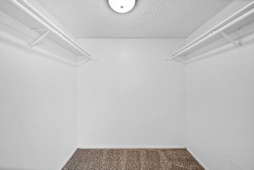 A room with a white ceiling and a brown carpet.