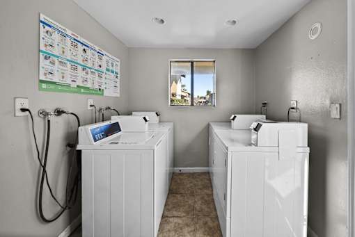 A bathroom with two sinks and a large poster on the wall.