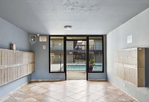 A room with a pool visible through the glass door.