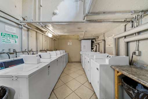 A laundry room with washers and dryers.