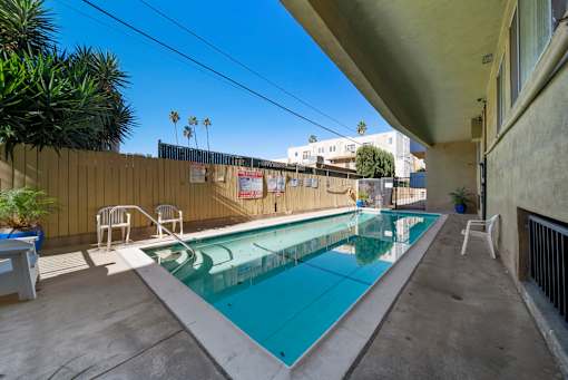 A small pool with a concrete floor and a concrete wall.