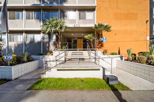 The image shows the front of a building with the number 6711 on it.
