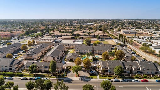 A suburban neighborhood with houses and parked cars.