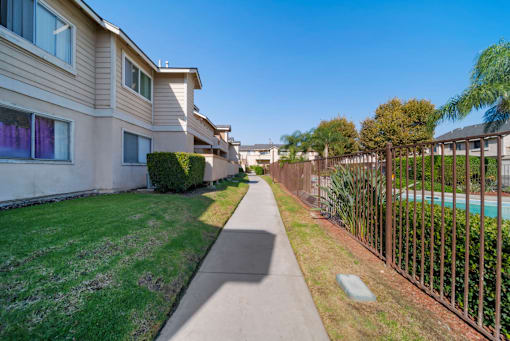 A sunny day in a residential area with a clear blue sky.