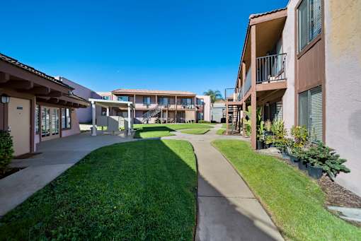 A sunny day at a residential complex with a clear blue sky.