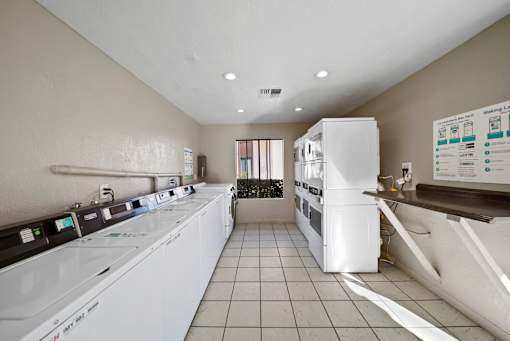 A laundry room with washers and dryers.