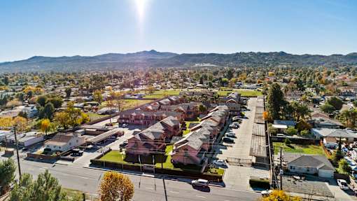 A sunny day in a residential area with houses and trees.