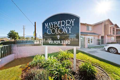 A sign for Mayberry Colony with a phone number on it.