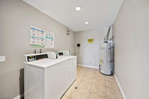 A clean, empty room with a white appliance and a poster on the wall.
